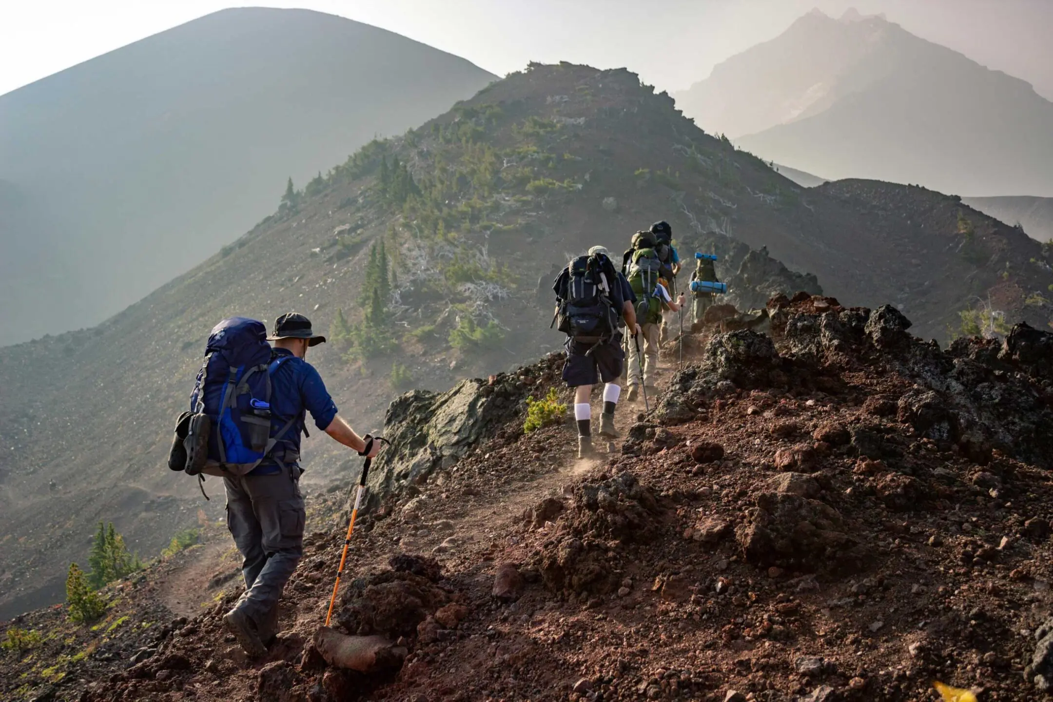 Group of people hiking remote mountain top